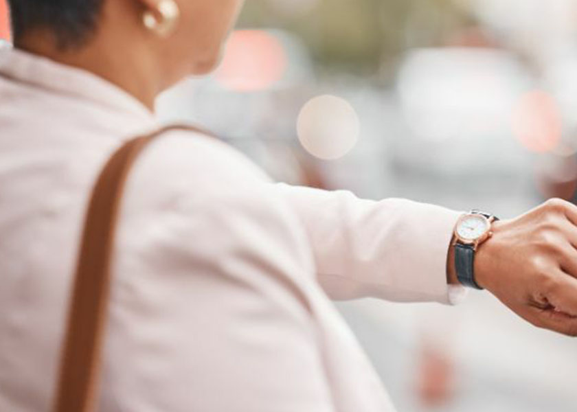 Businesswoman checking wristwatch