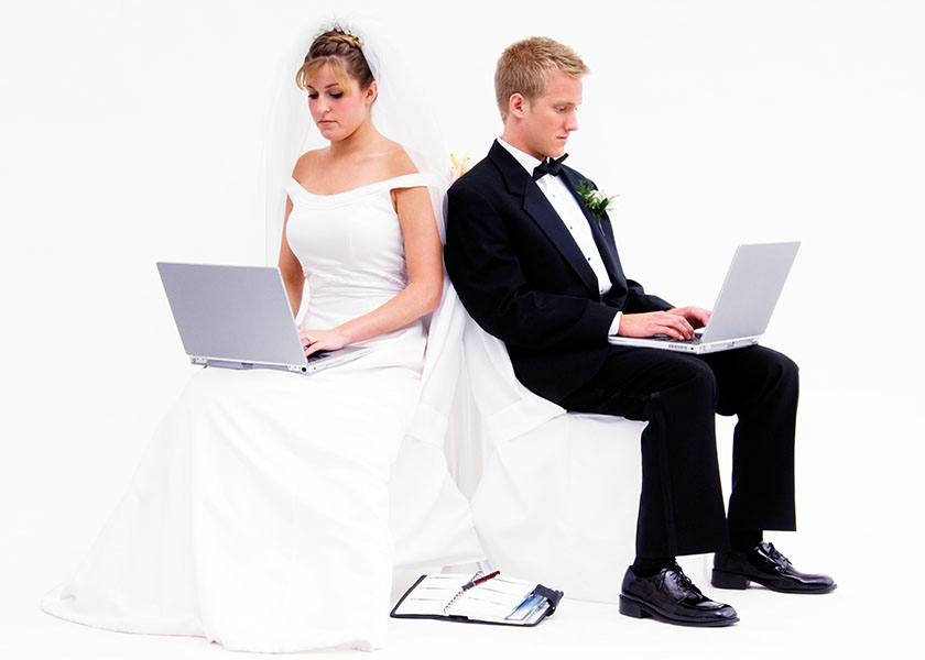 Bride and groom with laptops